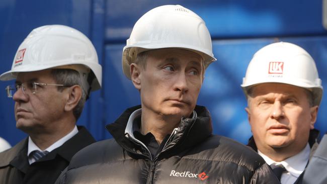 Vladimir Putin, centre, visits a Lukoil oil platform in the Caspian Sea, southeast of Moscow.