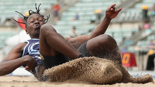 Kipchumba Langat of Wagga Wagga High School hit the sand after a big jump.