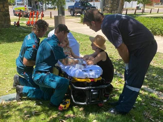 Paramedics treat Lisa Fitzgerald's daughter after she was bitten by a snake. Photo: Facebook