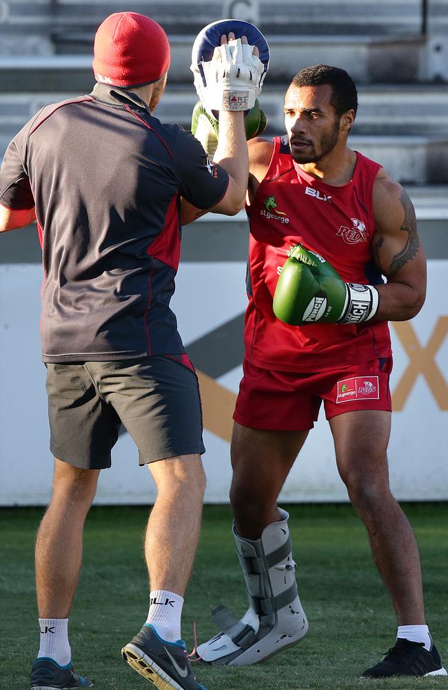 Wearing a moon boot on his right foot, Will Genia engages in some boxing training at Ballymore.