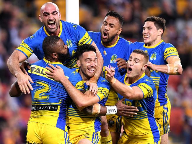 Semi Radradra of the Eels is congratulated by team mates after scoring a try against the Broncos.