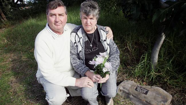 Peter and Sheila MacDiarmid with flowers left on a memorial to Sarah at the station.