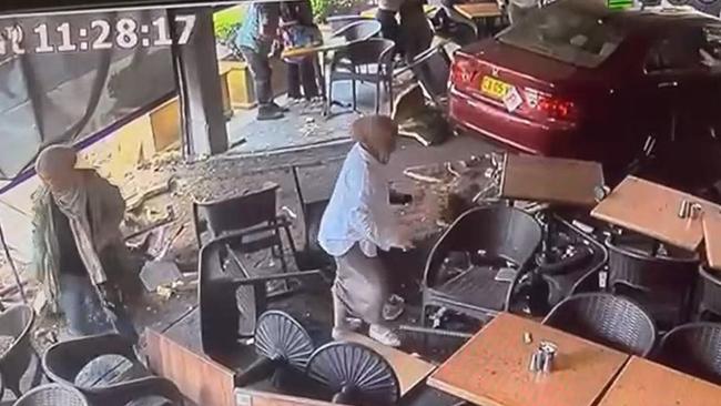 CCTV shows the car accelerating into several diners at the cafe in Bankstown. Picture: Supplied CCTV