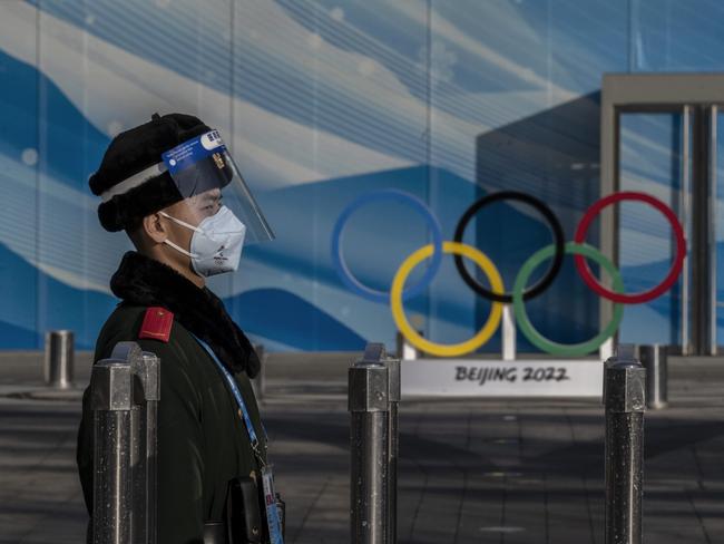 BEIJING, CHINA - JANUARY 29: A police officer stands guard inside the closed loop bubble to protect against the spread of COVID-19 for the Beijing 2022 Winter Olympics near the main media center at the Olympic Park on January 29, 2022 in Beijing, China. Athletes, officials, and journalists arriving to China for the Winter Olympics are required to stay in a bubble to prevent the spread of coronavirus as China continues to maintain its zero COIVD policy. The games are set to open on February 4th. (Photo by Kevin Frayer/Getty Images)