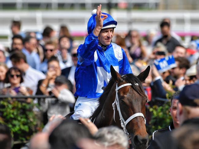 And the winner is: Hugh Bowman and his signature gesture as he returns to scale following Winx’s incredible Turnbull Stakes win. Picture: Jason Edwards