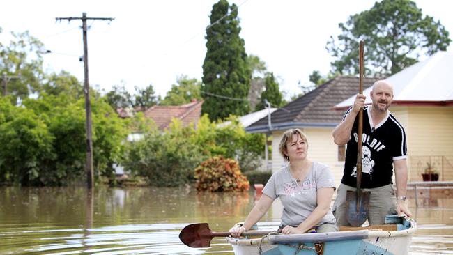 Graceville residents Ken and Georgina Evans were able to see the damage done to their home, borrowing a neighbours shovels to use as makeshift oars. They had to evacuate their home by wading through the floodwaters as the water rose.