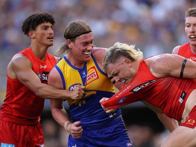 PERTH, AUSTRALIA - MARCH 16: Harley Reid of the Eagles wrestles with Nick Holman of the Suns during the round one AFL match between West Coast Eagles and Gold Coast Suns at Perth Stadium, on March 16, 2025, in Perth, Australia. (Photo by Paul Kane/Getty Images)