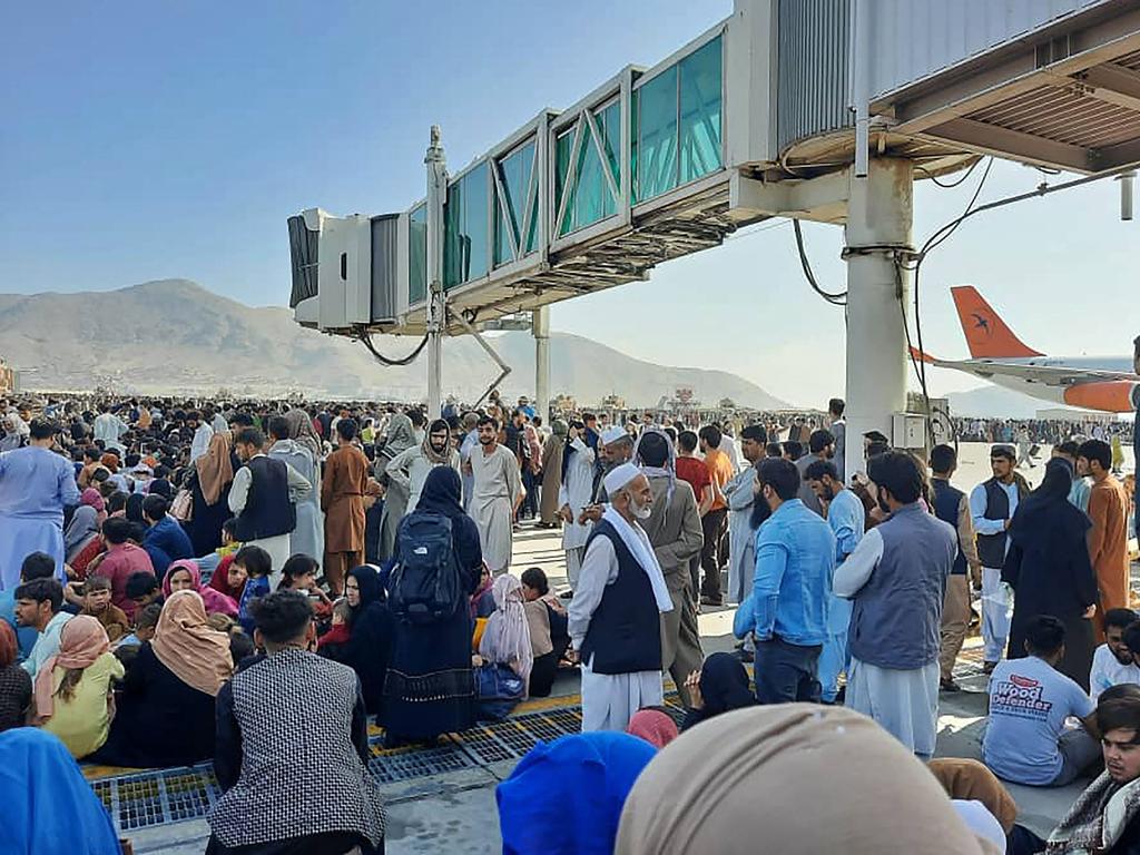 Afghans crowd at the tarmac at Kabul Airport as they wait for help getting out of Afghanistan. Picture: AFP