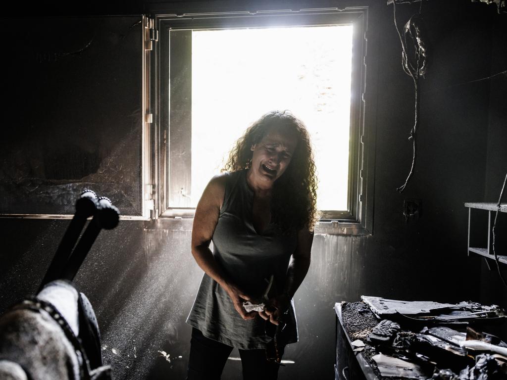 Kibbutz Nir Oz resident Hadas Kalderon, whose children have been taken hostage, and her mother and niece killed, breaks down in tears while looking through the burnt out home of her late mother Rina Sutzkever in October in Israel. Picture: Dan Kitwood/Getty Images