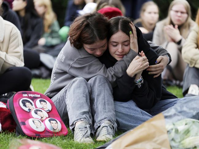 Munich: Mourning fans gather around a tree adorned with flowers, handwritten messages and photos near the Olympiahalle, Germany. Picture: Johannes Simon/Getty Images