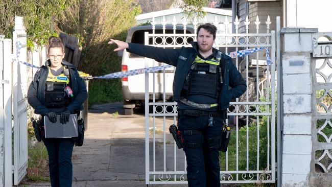 Police guard the entrance to the home where the man was found. Picture: Tony Gough