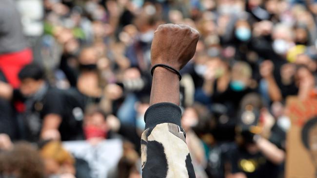 Protesters take a knee and raise fists in a moment of silence for George Floyd in Boston. Picture: AFP)