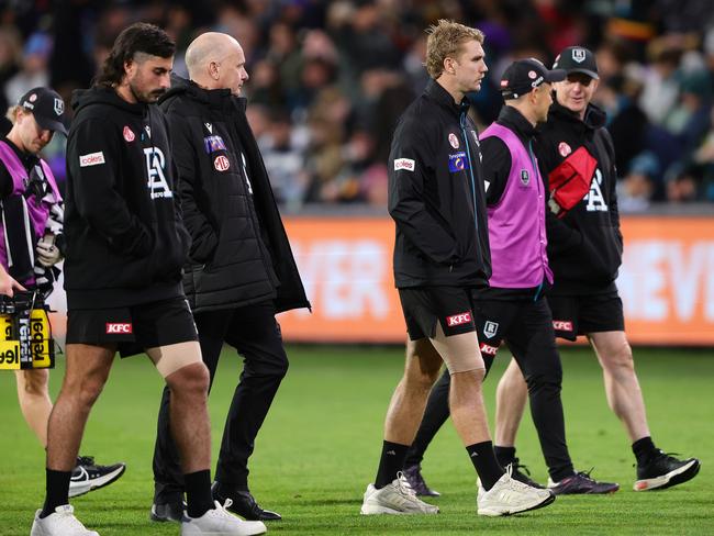 Ken Hinkley and his injured guns Jason Horne-Francis and Lachie Jones walk off Adelaide Oval. Picture: Sarah Reed/AFL Photos