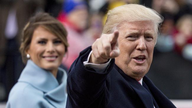 President Donald Trump, accompanied by first lady Melania Trump, points to members of the crowd as they walk in his inaugural parade on Pennsylvania Ave. outside the White House in Washington, Friday, Jan. 20, 2017. (AP Photo/Andrew Harnik)