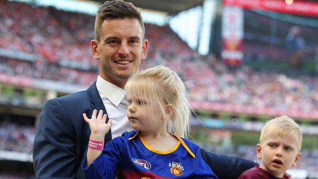 Jarryd Lyons with his children, Lara and Sebastian, at the AFL grand final retirement motorcade at the MCG. Picture: Lachie Millard