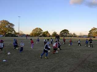 KEEN KIDS Football Queensland Aldi Miniroos development officer Andy Allan leads young players through an exercise. Picture: Jason Gibbs