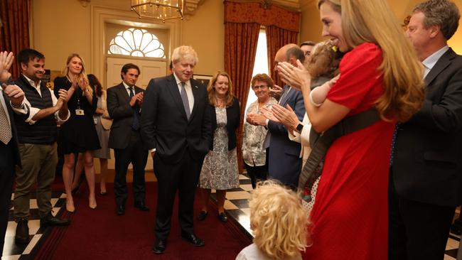 Prime Minister Boris Johnson is greeted by staff and his son Wilfred as he arrives back into No. 10 after resigning as the leader of the Conservative Party. Picture: Supplied