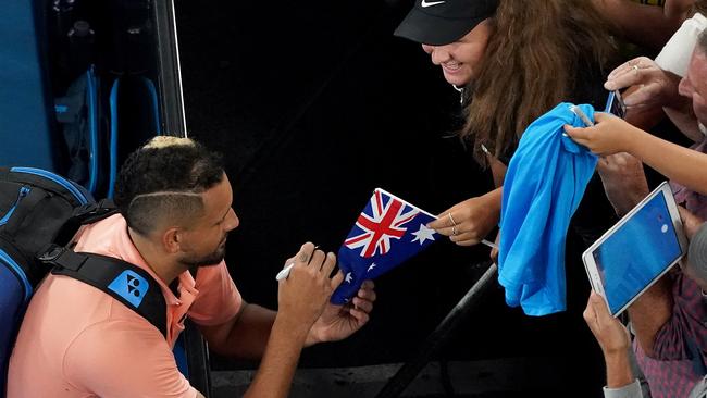 The new-look Nick Kyrgios signs autographs after winning his first round match against Lorenzo Sonego of Italy. Picture: Michael Dodge/AAP