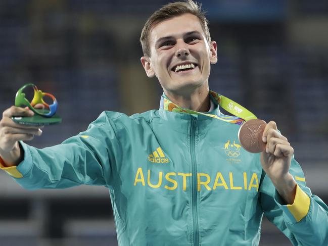 Bronze medal winner Australia's Dane Bird-Smith celebrates on the podium after the men's 20km race walk during the athletics competitions of the 2016 Summer Olympics at the Olympic stadium in Rio de Janeiro, Brazil, Friday, Aug. 12, 2016. (AP Photo/David Goldman)