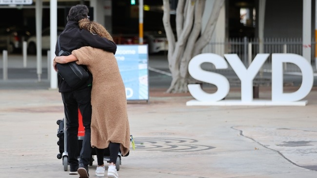 Two people are seen embracing outside Sydney Airport as quarantine arrangements changed on Monday. Picture: NCA NewsWire / Dylan Coker