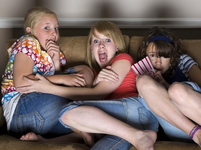 Three young girls huddled together on a couch watching a scary movie.  [url=search/lightbox/3091443] [img]http://richlegg.com/istock/banners/happy_children_banner.jpg[/img][/url] [b][url=search/lightbox/3091443]Click HERE to see my other HAPPY CHILDREN images[/url][/b]  [url=search/lightbox/11380995] [img]http://richlegg.com/istock/banners/eray_banner.jpg[/img][/url] [b][url=search/lightbox/11380995]Click here to see more of this model[/url][/b]  [url=search/lightbox/2239437] [img]http://richlegg.com/istock/banners/movies_banner.jpg[/img][/url] [b][url=search/lightbox/2239437]Click here to see more At The Movies images[/url][/b]