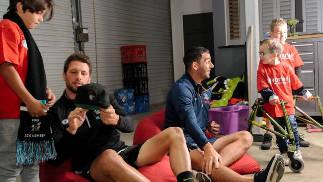Port fan Gary, 10, with Port Power captain Travis Boak and Adelaide Crows captain Taylor Walker talking to Finlay, 4, and Angus, 6, at a press conference held at Variety SA. Picture: AAP Image/Morgan Sette