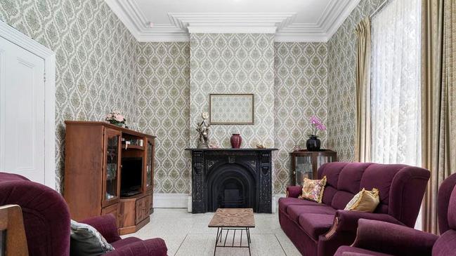 Original wallpaper and fireplaces are found throughout the home.