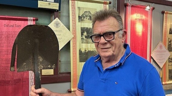 Darwin's Chung Wah Museum Director Neville Jones, featured in Jane Munday's book The Meeting Place. Mr Jones holds a shovel which has been shorted by the workers, something they did every time their pay was docked a shilling.