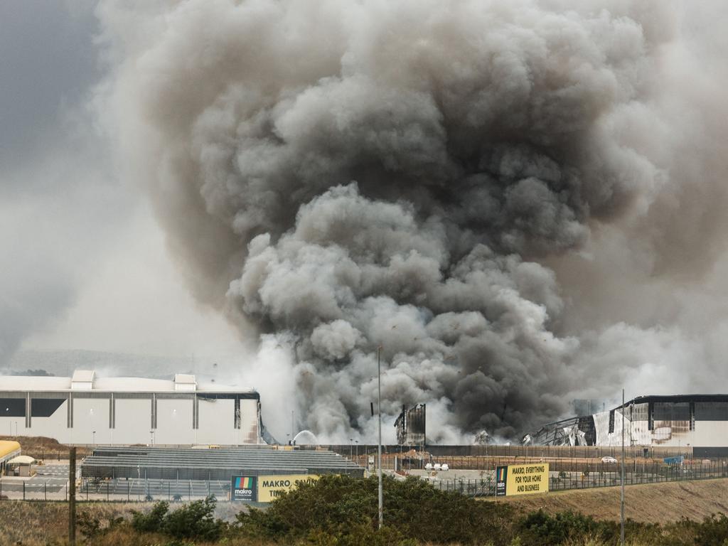 Smoke rises from a Makro building set on fire overnight in Umhlanga, north of Durban. Picture: AFP