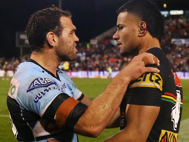 PENRITH, AUSTRALIA - JULY 23: Dale Finucane of the Sharks looks at the ear of Stephen Crichton of the Panthers after the  round 19 NRL match between the Penrith Panthers and the Cronulla Sharks at BlueBet Stadium on July 23, 2022, in Penrith, Australia. (Photo by Matt Blyth/Getty Images)