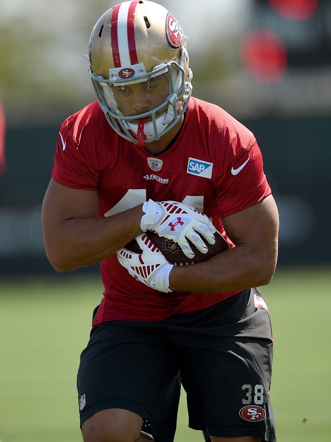 Hayne holding the ball tight during practice.