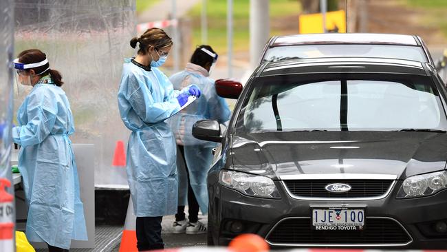 Medical staff prepare to take a swab at a drive-through testing clinic in Melbourne this week. Picture: William West/AFP