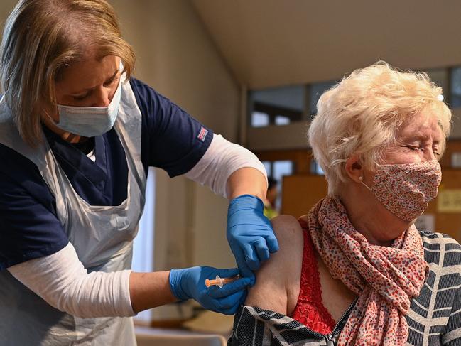 A member of the public receives the Oxford/AstraZeneca Covid-19 vaccine at a temporary vaccination centre in St Columba's Church in Sheffield, south Yorkshire on January 23, 2021. - Britain's Prime Minister Boris Johnson has revealed that 5.4 million people had now received their first dose of two vaccines currently being administered, with a daily record of 400,000 people inoculated in the last 24 hours. (Photo by Oli SCARFF / AFP)