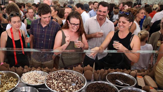 Customers looking at different kinds of insects at a stall in Sydney.