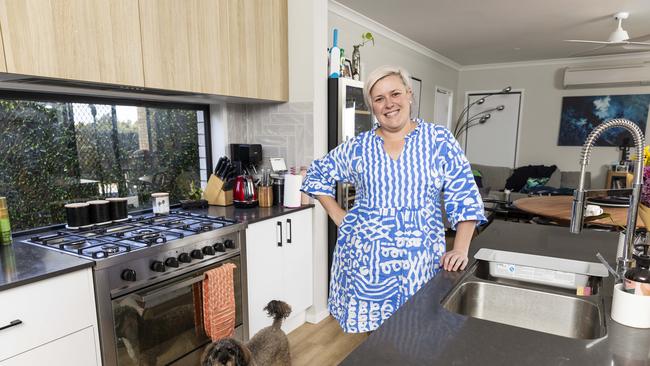 Kiah Coupland was assisted by her mother as a guarantor on her first home. Pictured is Kiah inside her home with her dog Coco.