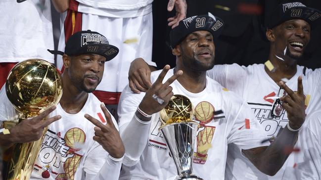 Dwyane Wade (L), LeBron James (C) and Chris Bosh (R) celebrate the Miami Heat 2013 championship. Picture: AFP PHOTO / Brendan SMIALOWSKI.