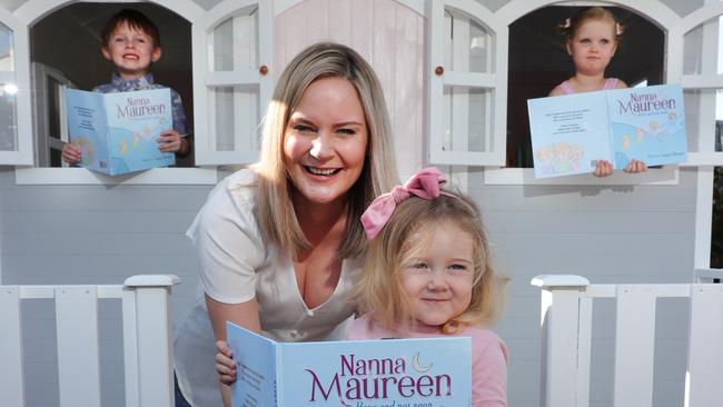 Casey Gillespie, reads her book, a story about her late mother called Nanna Maureen, to Jesse Gillespie, 4, Scarlett Gillespie, 2, and Harper Thyer, 4. Picture: Glenn Hampson.