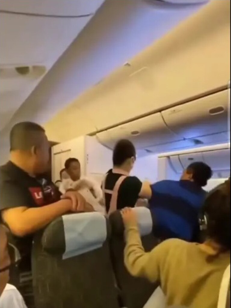 footage captured the brawl, which started about three hours into a long-haul flight.