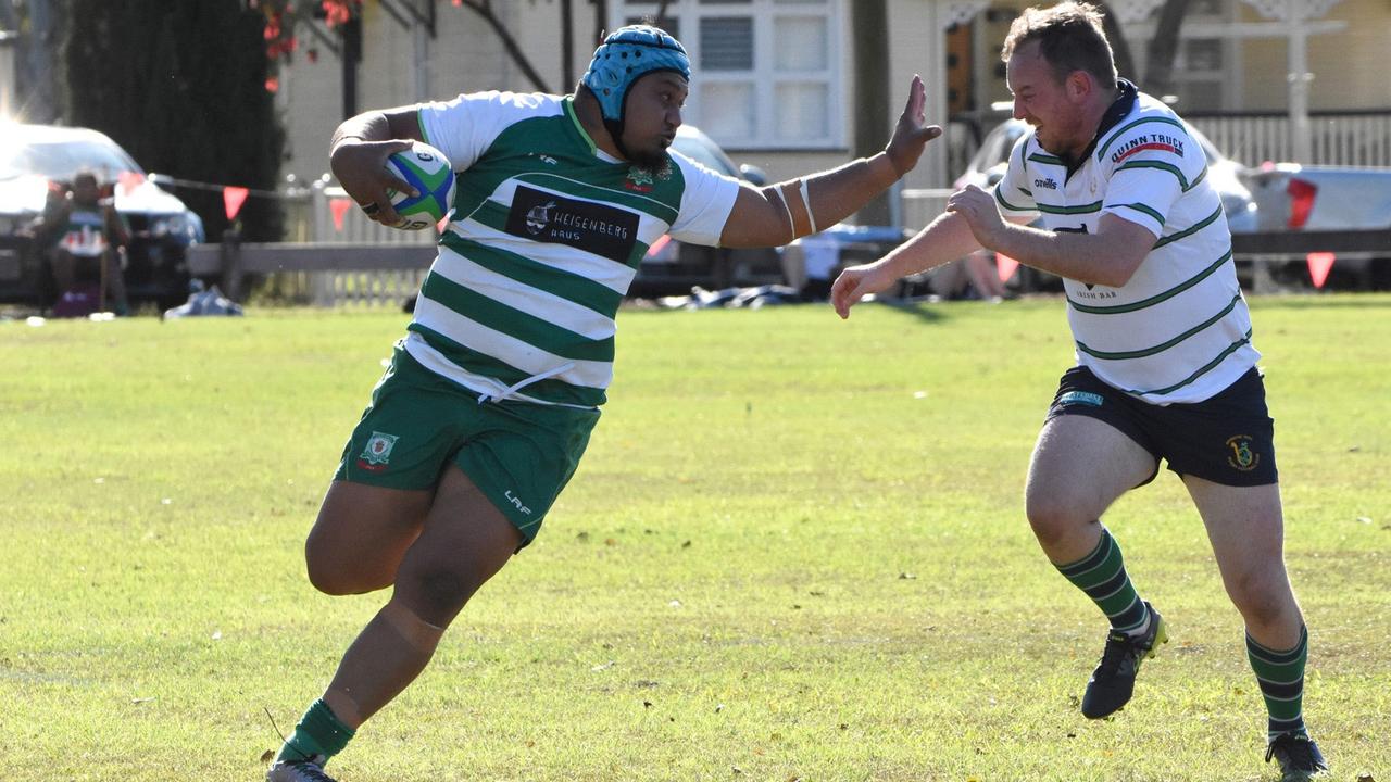 The Rangers player fends off the Brisbane Irish tackler in Saturday’s Barber Cup encounter at Woodend Park. Picture: Gary Reid