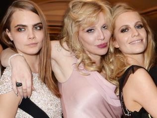 LONDON, ENGLAND - DECEMBER 01: (L to R) Karlie Kloss, Model of the Year winner Cara Delevingne, Courtney Love, Poppy Delevingne and Joan Smalls attend the British Fashion Awards at the London Coliseum on December 1, 2014 in London, England. (Photo by David M. Benett/Getty Images)