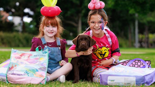 Elsie Donnelly, 4, and Eve Daher, 8, with some of their favourite showbags. Picture: Justin Lloyd.