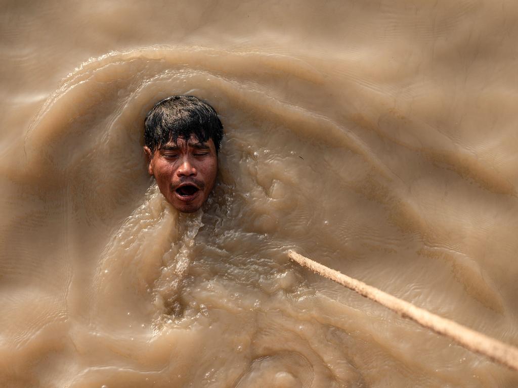 A diver emerges from a swim in the Yangon River after exploring a sunken ship. Picture: Sai Aung Main/AFP