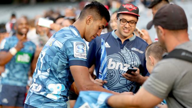 In what may be a rare sight for a while, Rieko Ioane of the Blues signs autographs following the round-seven Super Rugby match between against the visiting Lions on Saturday in Auckland. Picture: Getty Images