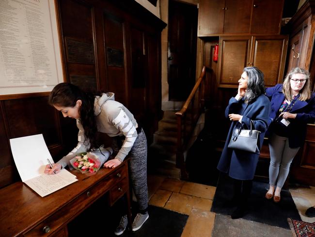 A woman signs a book of condolence book at Gonville and Caius College at Cambridge University, where British physicist, Stephen Hawking was a fellow for over 50 years. Picture: AFP Photo/Tolga Akmen
