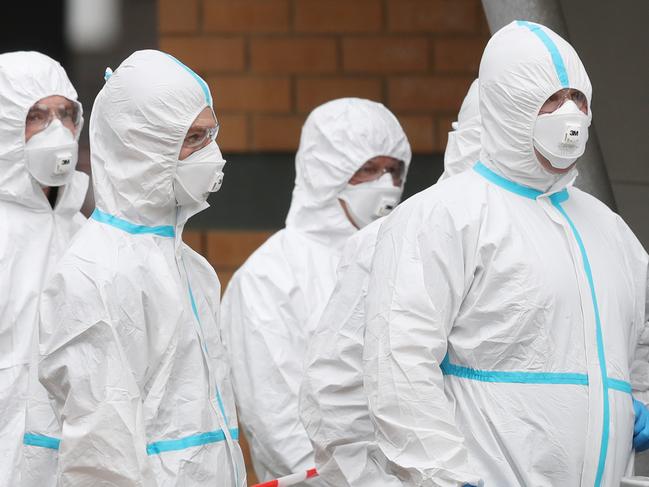 Firefighter in protective suits deliver food to the Towers in North Melbourne which have been  forced into lockdown by the government due to COVID-19. Tuesday, July 7, 2020. Picture: David Crosling