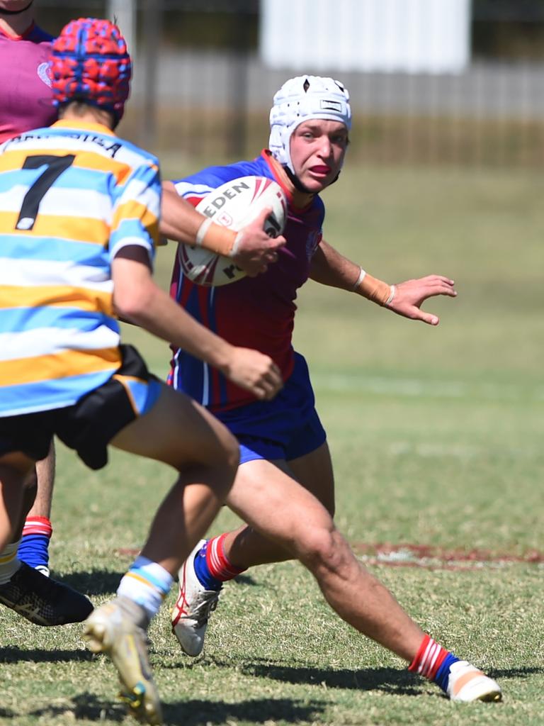 Boys Rugby League State Championship held at Northern Division, Brothers Leagues ground, Townsville. 16-18 years. Peninsula (stripe) v Darling Downs (blue/purple). Braithen Scott of St Mary's College, Toowoomba.