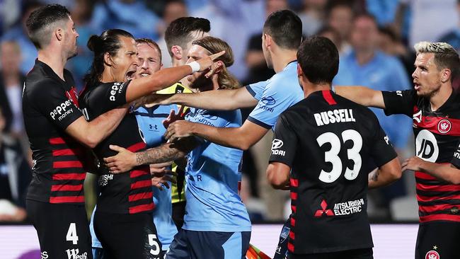 Daniel Georgievski is held back after kicking out at Marco Tilio. Picture: Matt King/Getty