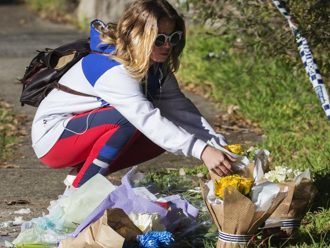 Jade Davis leaves flowers at the house today. Her younger sister went to school with Jack. Picture: Jenny Evans