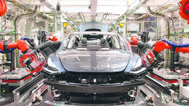 Robots at work on a Tesla at a factory in the United States. Picture: Brian Molyneaux