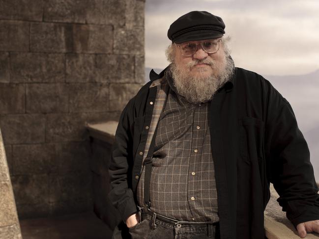 In this publicity image released by HBO, author George R.R. Martin whose novel series have been adapted into the HBO series "Game of Thrones," is shown on the set. (AP Photo/HBO, Nick Briggs )